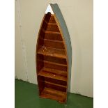 An open bookcase in the shape of a boat