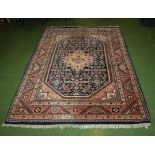 A large blue and peach ground rug, 2.10m x 1.4m