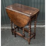 An oak gate legged table with barley sugar legs