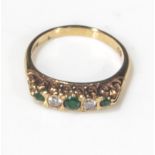 An 18ct yellow gold emerald and diamond 5 stone ring, size P