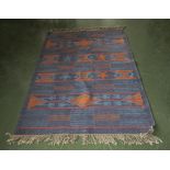 A blue cotton Aztec design rug