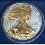 A 2004 silver dollar with 24c gilding