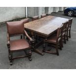 A carved oak refectory table with six dining chairs and one carver