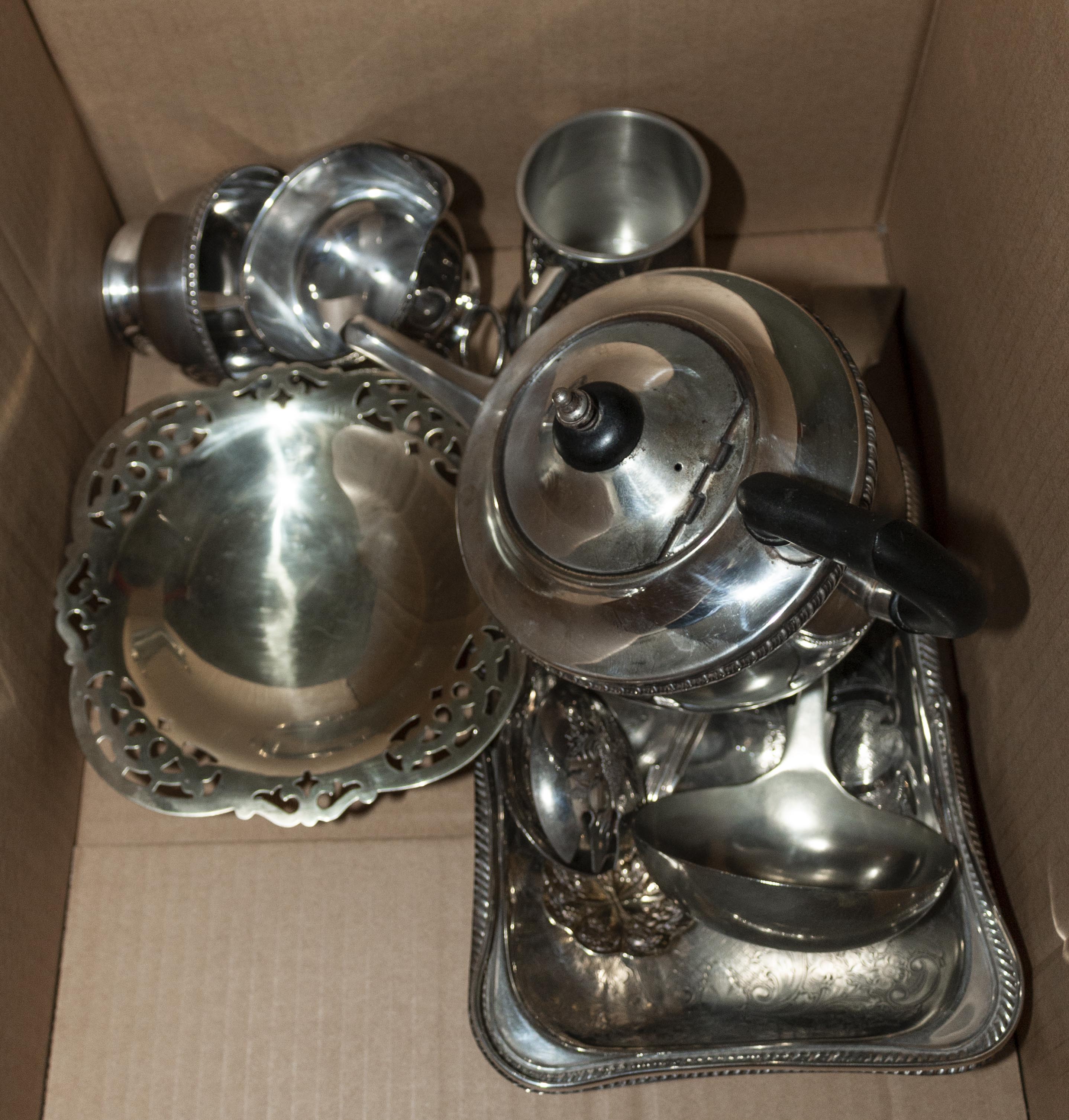 A box containing silver plated items