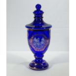 A blue glass lidded urn