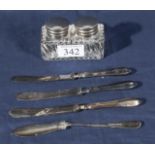 An inkwell and four silver knives
