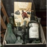 A box containing a collection of vintage glass bottles