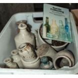 A box containing a collection of vintage stoneware bottles