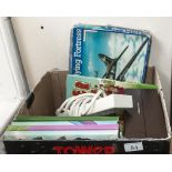 A box containing books, prints, a jigsaw and other items