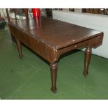 An oak extending dining table (matches chairs lot 287)