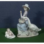 A Lladro figure group of a girl with a goose together with a small Nao figure