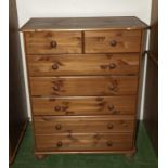 A pine chest of drawers two over five