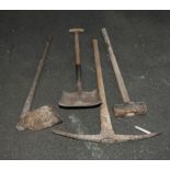 A sledge hammer, two picks and a shovel