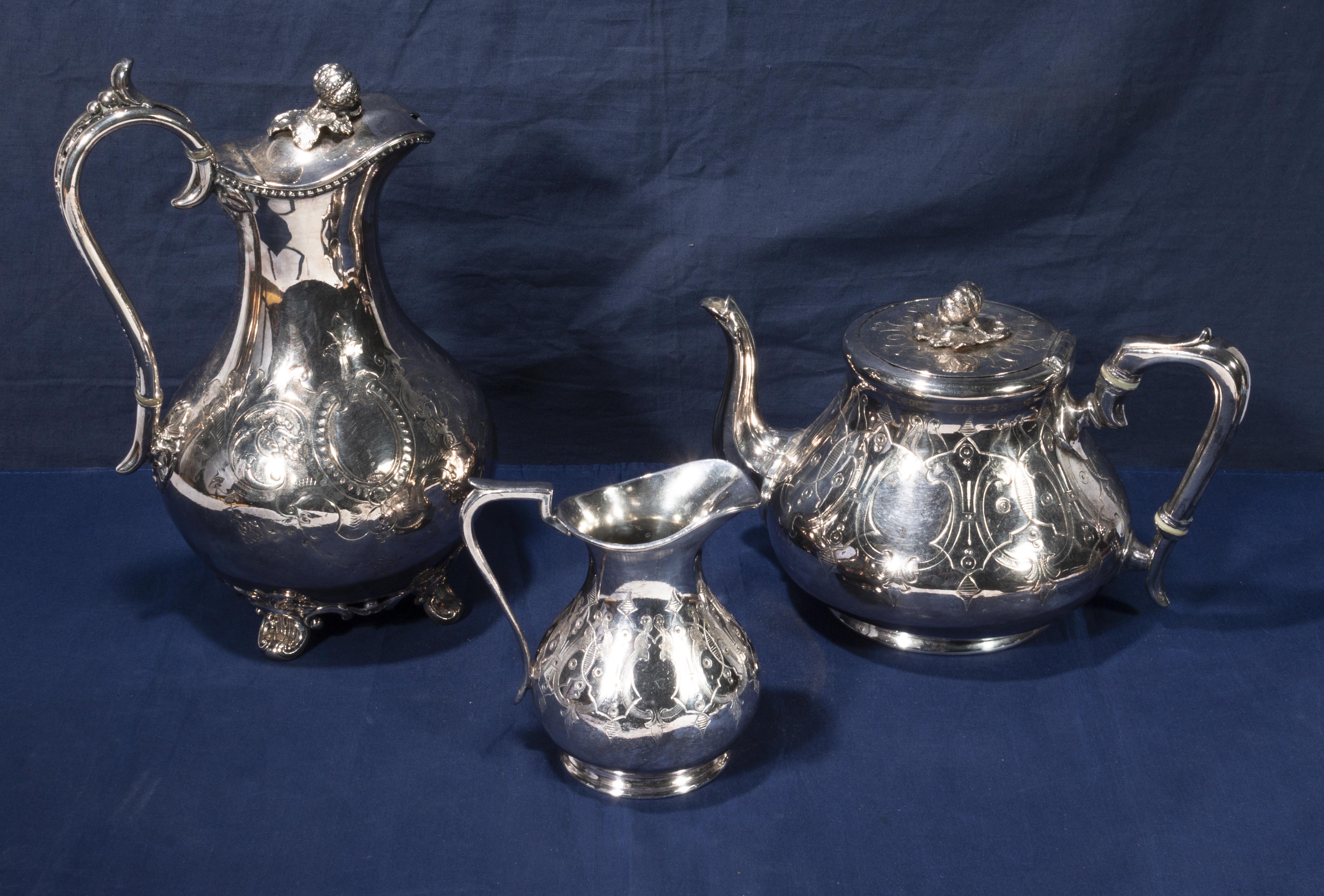 A silver plated teapot and cream jug with a silver plated water jug