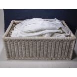 A basket containing children's vintage Christening gowns