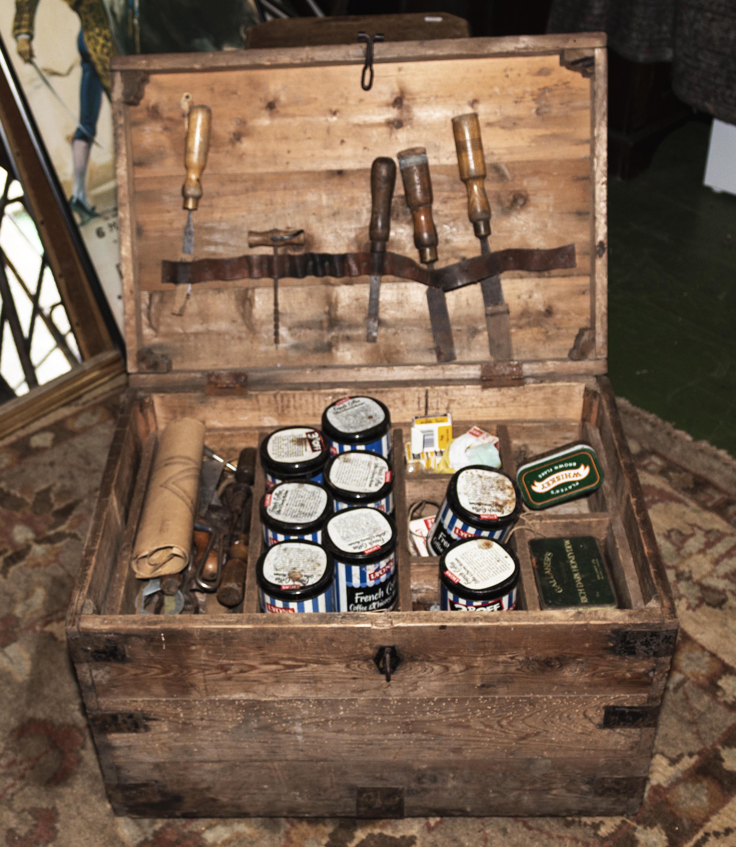 A pine box with various vintage tools
