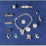 A silver charm bracelet with 13 charms. 51gms