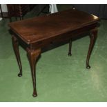 An Edwardian mahogany turn over top tea table.