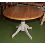 A circular pine kitchen table