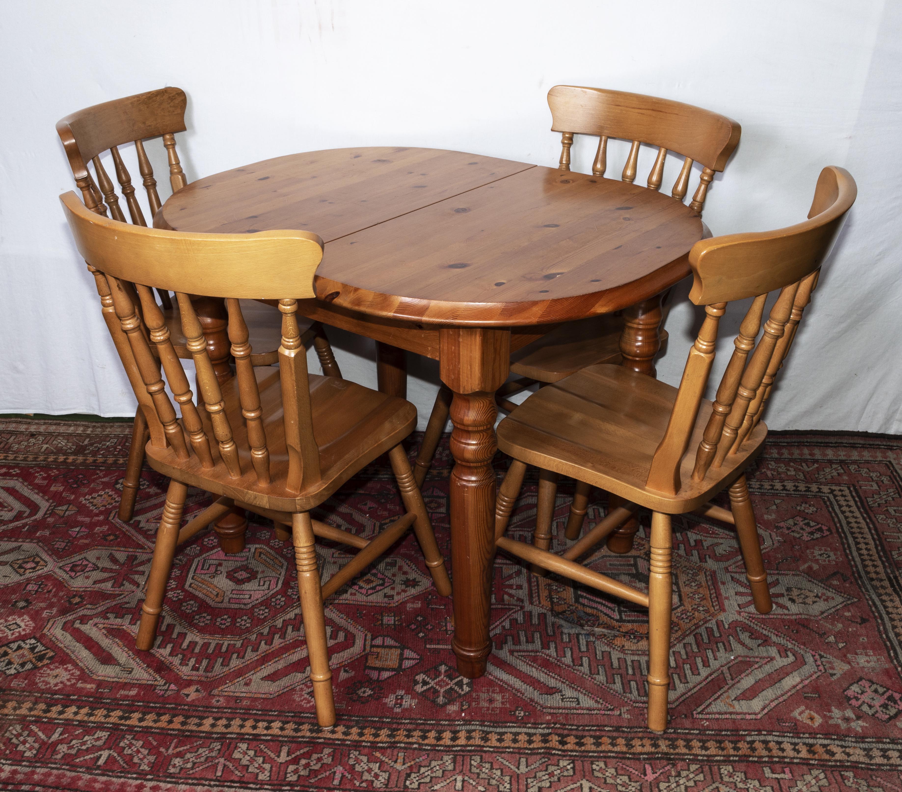 A pine extending kitchen table and four chairs