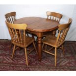 A pine extending kitchen table and four chairs