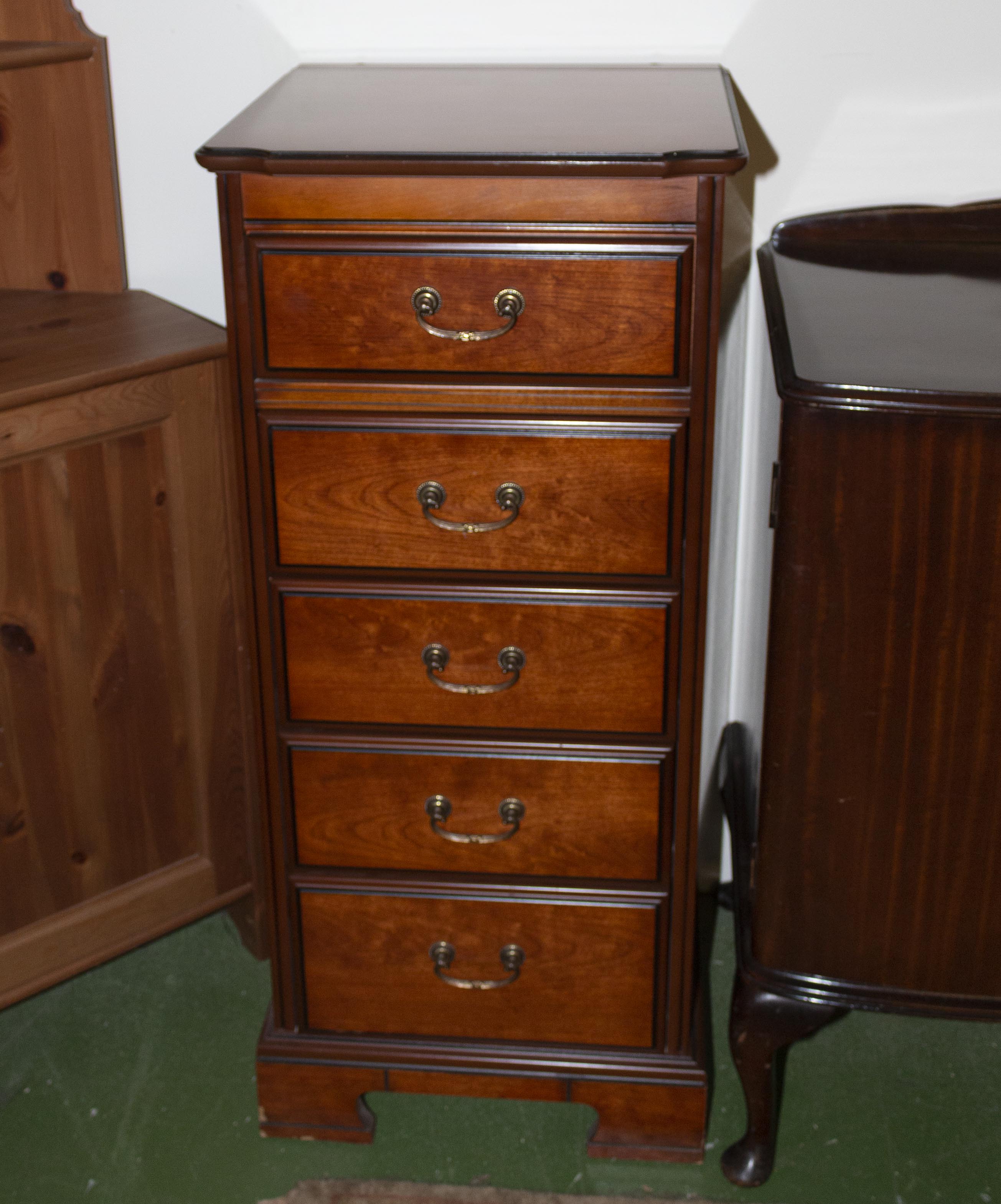 A tall chest of five drawers