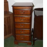 A tall chest of five drawers