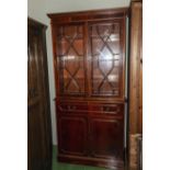 A reproduction yew wood bookcase.