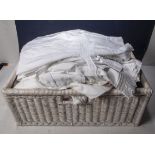 A basket containing children's vintage nightgowns and other items