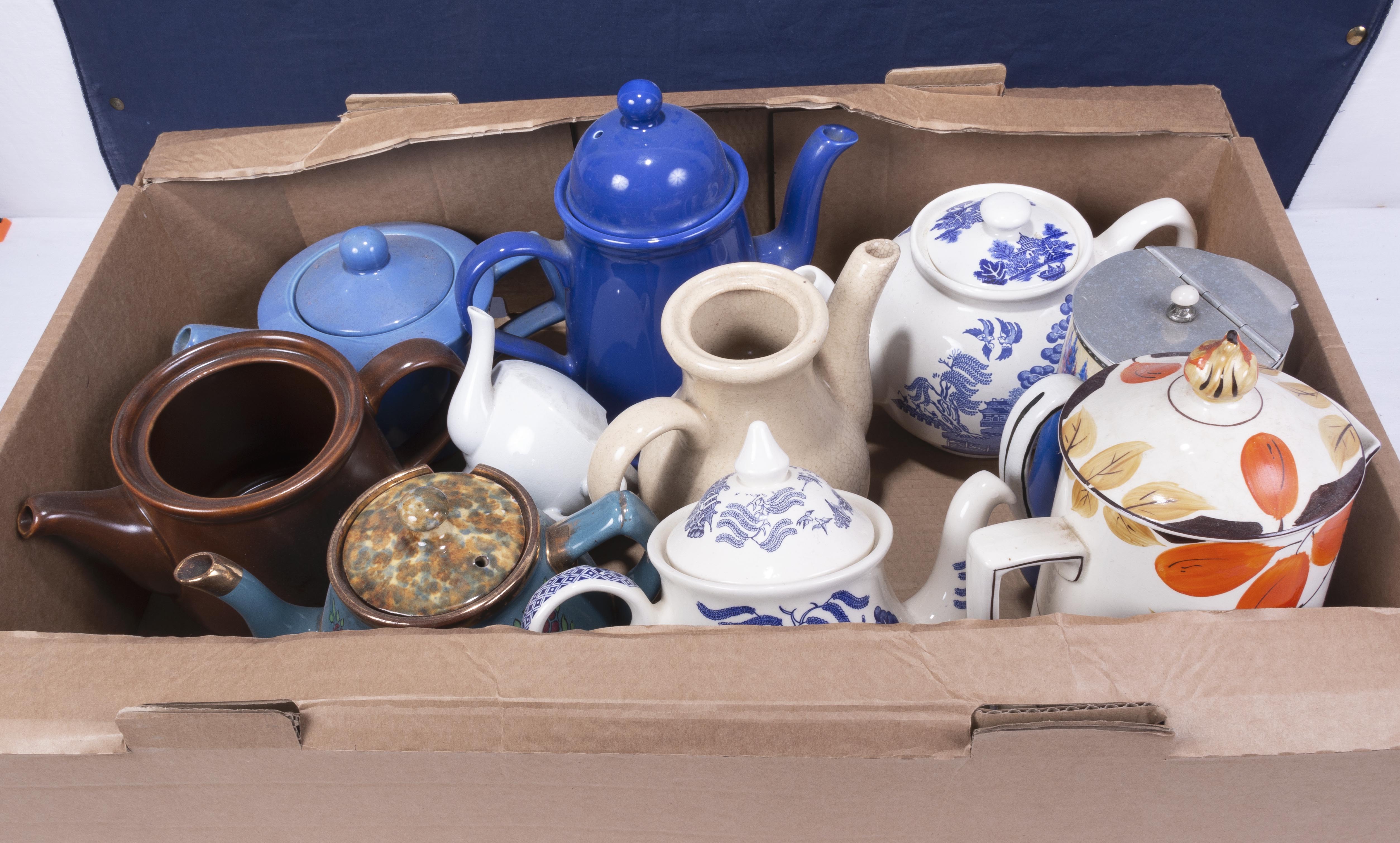 A box of assorted pottery teapots