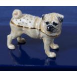 A small porcelain figure of a pug dog