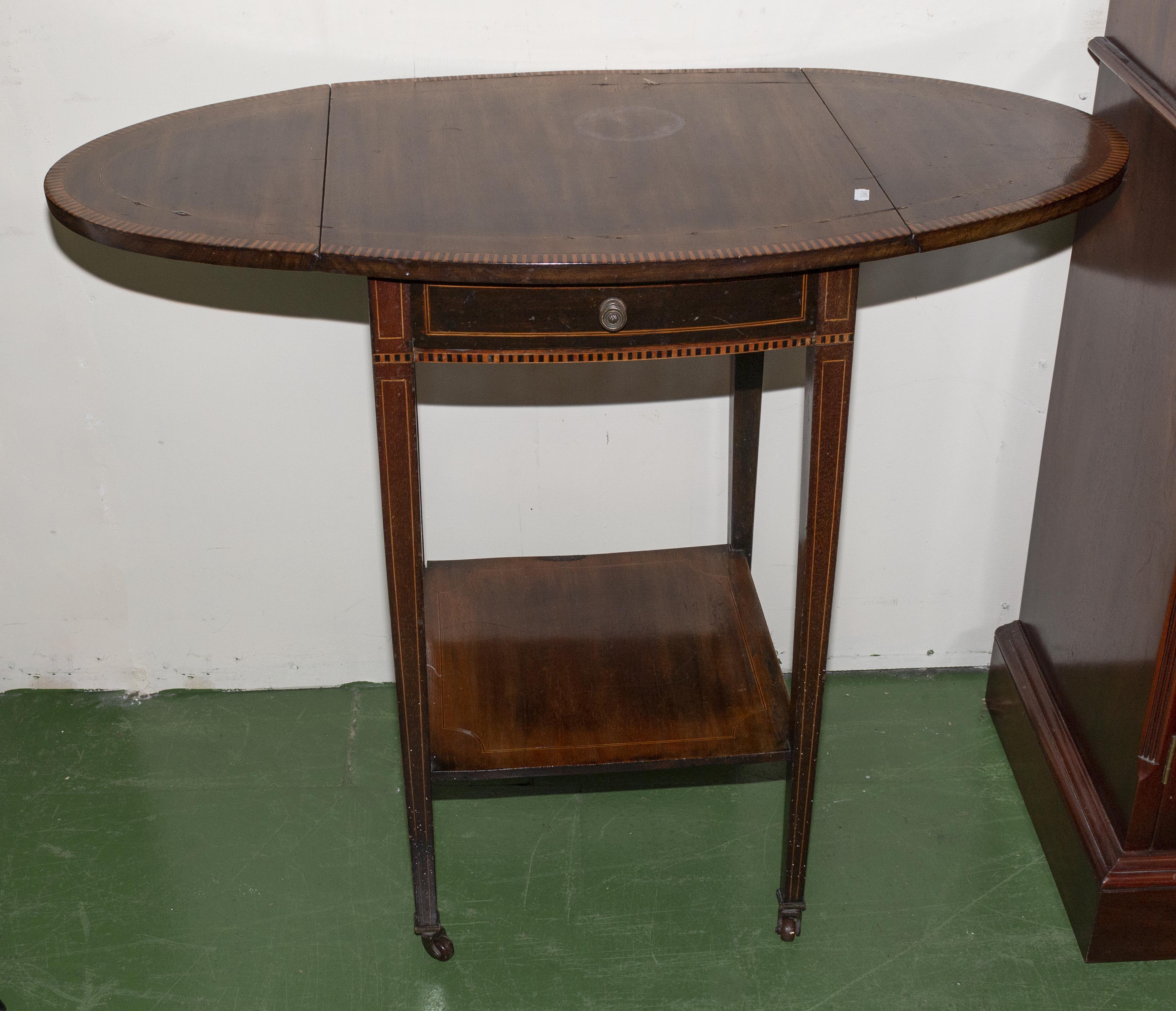 An Edwardian inlaid mahogany drop leaf table.