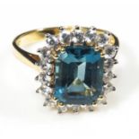 An 18ct gold ring set with a blue topaz and diamonds 75 point, size O