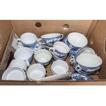 A box containing blue and white tea ware