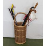 A basket containing sticks and umbrella