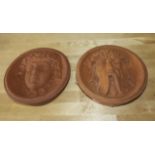 Two terracotta wall plaques