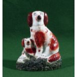 A Staffordshire flat back, spaniel and puppy