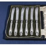 A cased set of silver butter knives