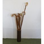 A ceramic stick stand and walking sticks and crooks