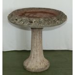 A reconstituted stone bird bath.