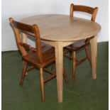 A pine table and two chairs