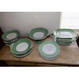 A quantity of green and white dinner ware