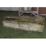 A reconstituted stone trough