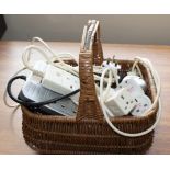 A basket containing electrical extensions and plugs