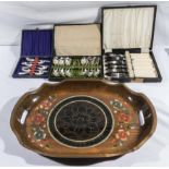 Three cased sets of cutlery and a tray