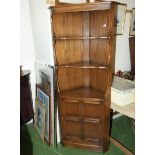 An Ercol corner cabinet.