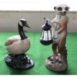 A Meerkat garden ornament and a duck