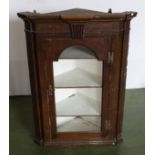 A Georgian oak corner cabinet.