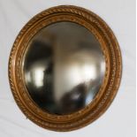 A gilt plaster framed circular mirror