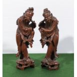 A pair of Q'ing Dynasty hardwood carved figures of fishermen